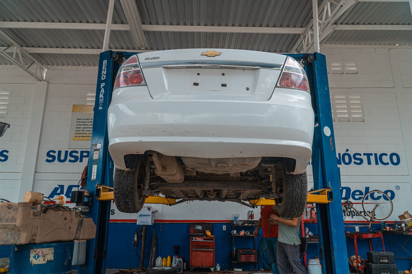 A car raised on a lift, seen from behind
