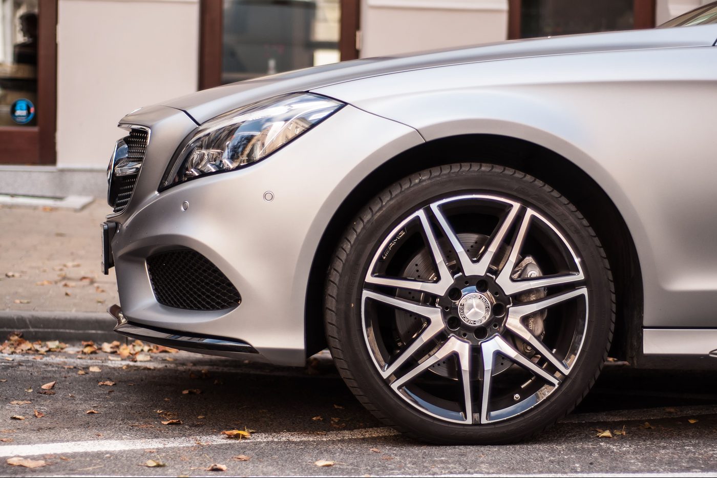 The alloy wheel of a parked saloon